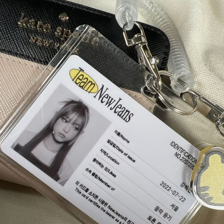 a close up of a person's identification card on a bag with a keychain