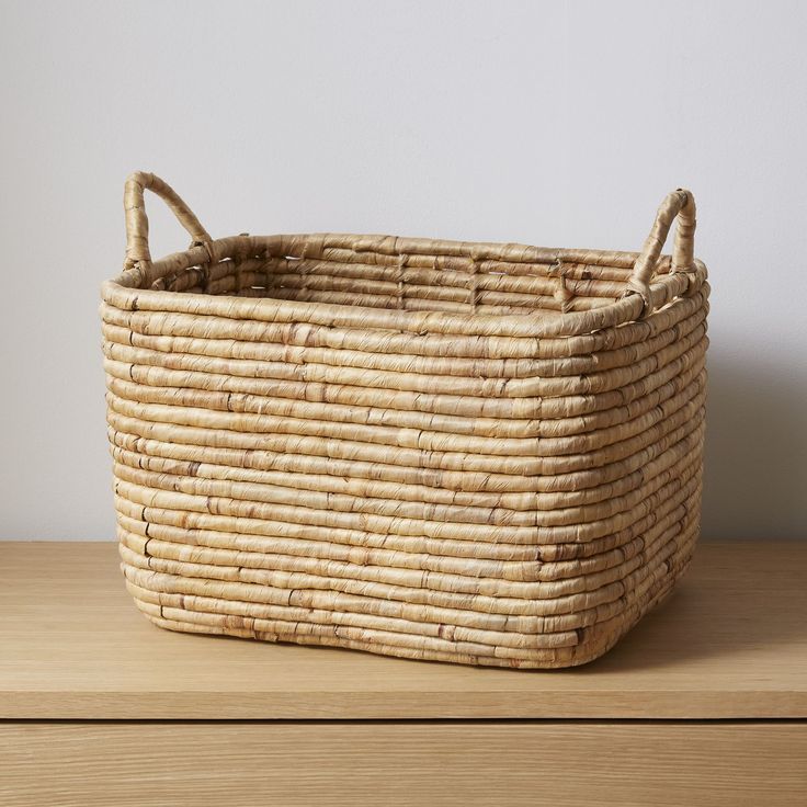 a woven basket sitting on top of a wooden table