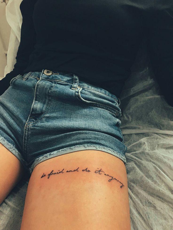 a woman laying on top of a bed with her legs crossed and the words behind her