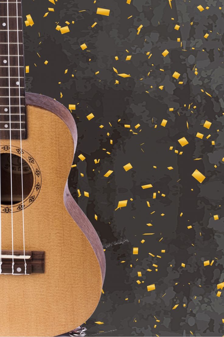 an acoustic guitar is surrounded by confetti