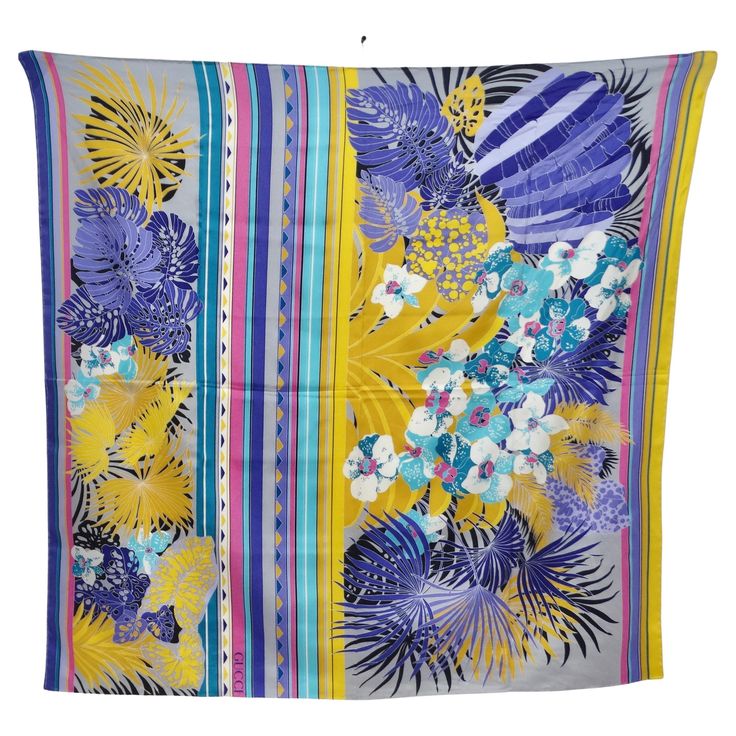 Introducing the Gucci 1980s Floral Silk Scarf, a stunning and vibrant accessory that encapsulates the bold and eclectic style of the 1980s. Crafted from luxurious silk, this scarf features a captivating floral print mixed with multicolor stripes and geometric motifs, creating a whimsical and eye-catching design. The vibrant pinks, blues, yellows, and purple hues dance across the scarf, adding a pop of color and vibrancy to any outfit. The eclectic mix of floral and geometric patterns reflects th Fendi Handbag, Chanel Necklace, Floral Silk Scarf, Geometric Motifs, Versace Sunglasses, Eclectic Style, Purple Hues, The 1980s, Mixing Prints