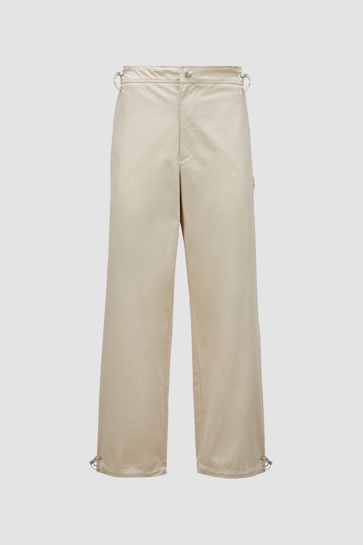 Crafted from soft cotton canvas, these slacks are fit a range of occasions. Drawstring fastening on the waist and cuffs enhance comfort. Chino Cotton Twill Straight Pants With Belt Loops, Chino Cotton Twill Work Pants With Belt Loops, Beige Chino Cotton Twill Pants With Straight Hem, Wide Leg Chino Cotton Twill Bottoms With Belt Loops, Beige Chinos For Work With Straight Hem, Wide Leg Chino Cotton Twill Pants With Belt Loops, Chino Cotton Twill Pants For Work, Cotton Wide-leg Chinos With Belt Loops, Beige Wide-leg Workwear Parachute Pants