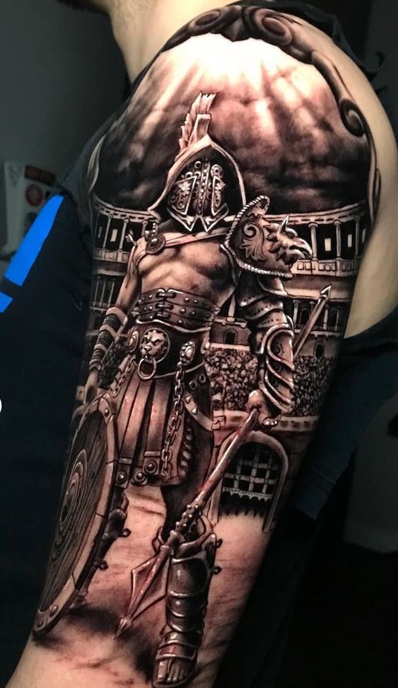 a man with a black and grey tattoo on his arm