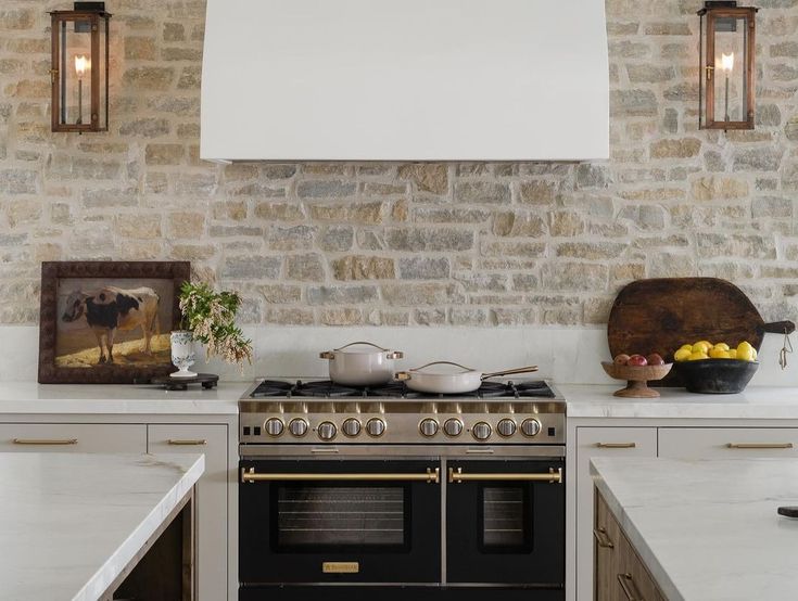 a stove top oven sitting inside of a kitchen next to a wall mounted light fixture