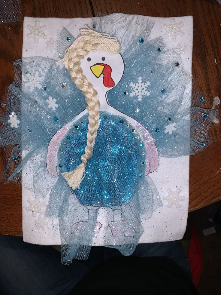 a paper plate with an image of a chicken wearing a blue tutu and braid