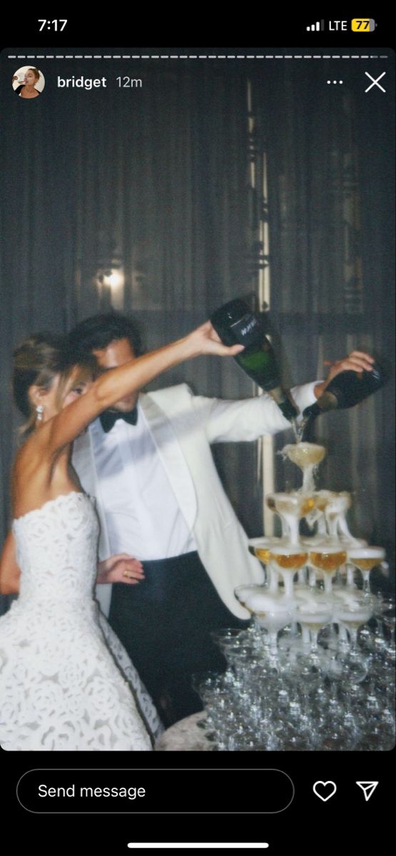 a bride and groom cutting their wedding cake at the end of their reception with champagne being poured on them