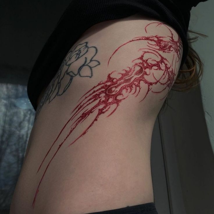 a woman's thigh with red ink on it