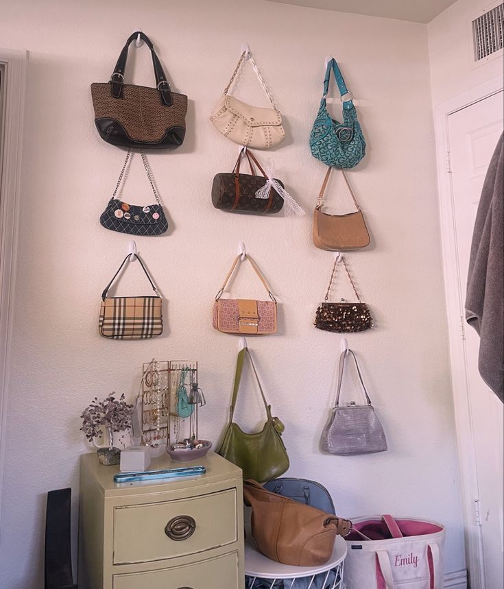 purse wall, room decor, purse display, purses, wall art Handbags On Wall, Bedroom Handbag Display, Purses On Wall Aesthetic, Room Purse Display, Bag Hooks Wall Bedroom, Purse Hanging Ideas Bedrooms, Purse On Wall, Creative Purse Display, Wall Purse Organization