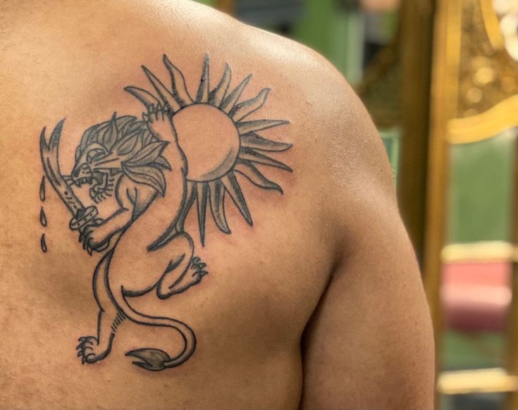 a man with a dragon tattoo on his back