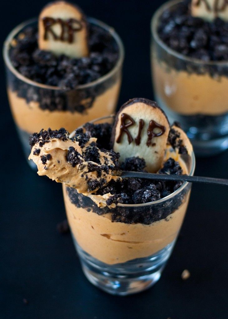 three desserts in small glasses with chocolate chips and marshmallows on top