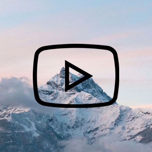 an image of a mountain with a play button in the foreground and clouds below