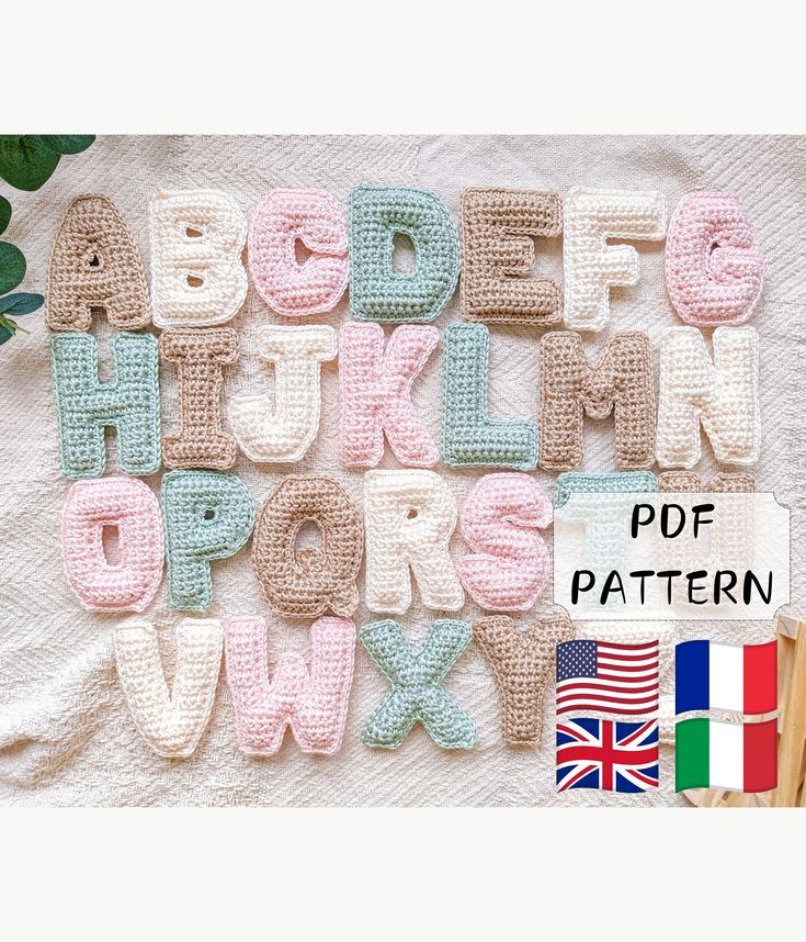 crocheted letters and numbers are displayed on a blanket