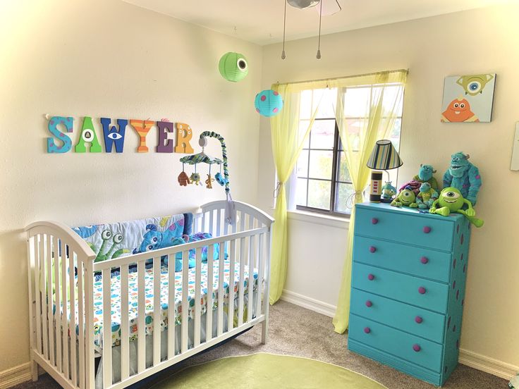 a baby's room with a crib, dresser and toy chest in it