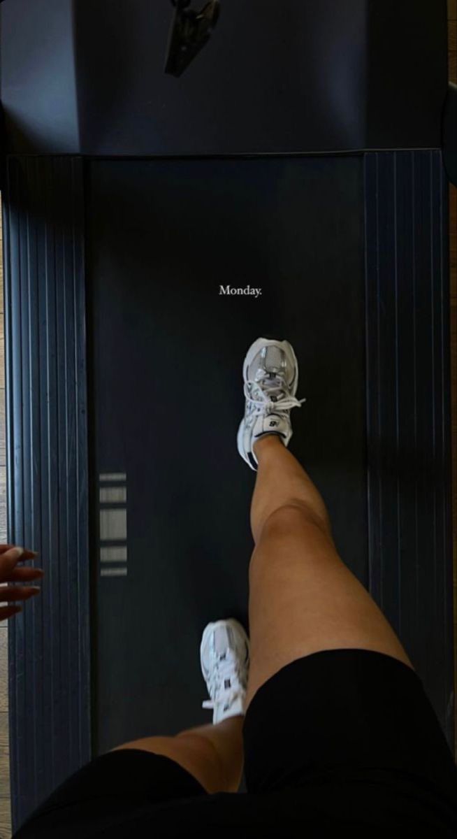 a person standing on top of a black box next to a white shoe and an apple watch