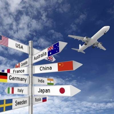 an airplane is flying over a sign post in the sky with flags and countries on it