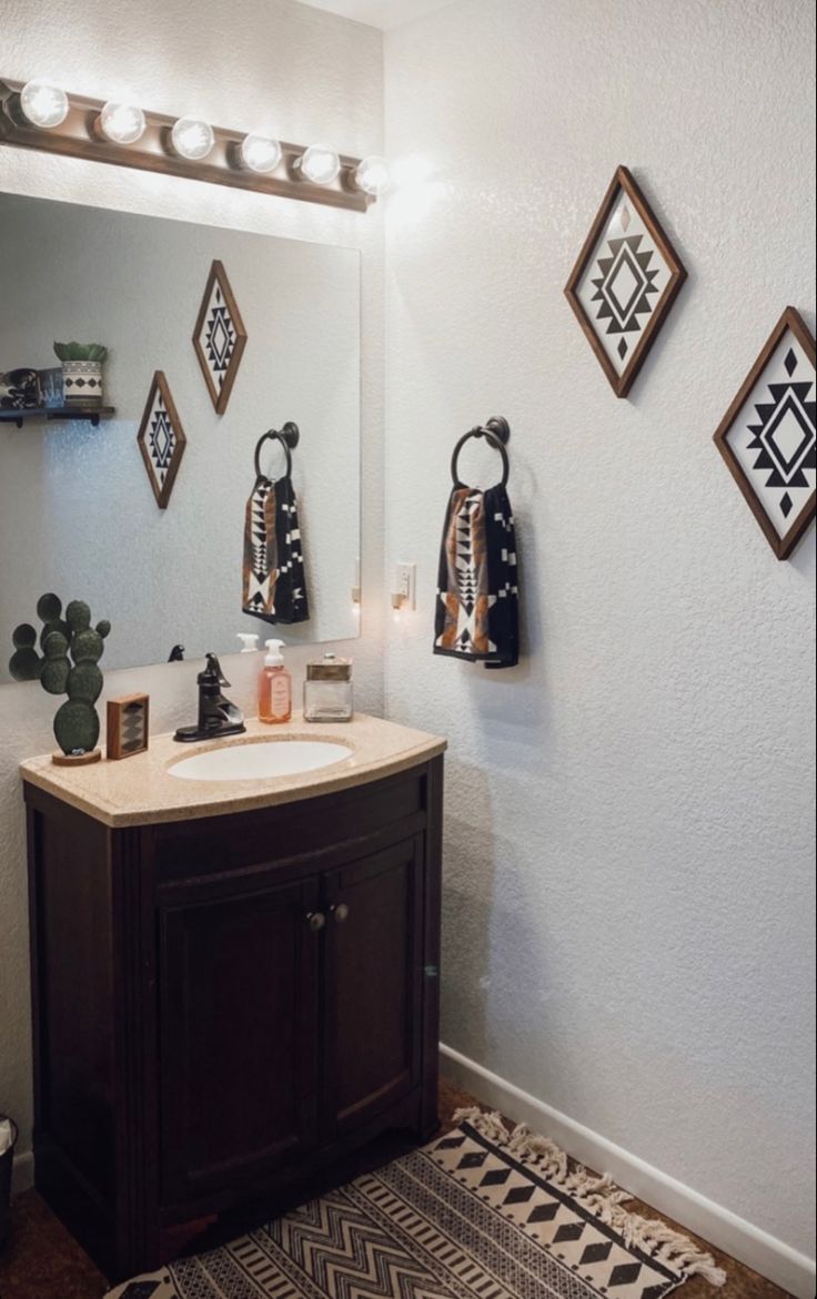 a bathroom with a sink, mirror and rug on the floor in front of it