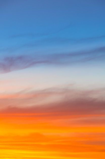 an airplane is flying in the sky at sunset or sunrise with orange and blue colors