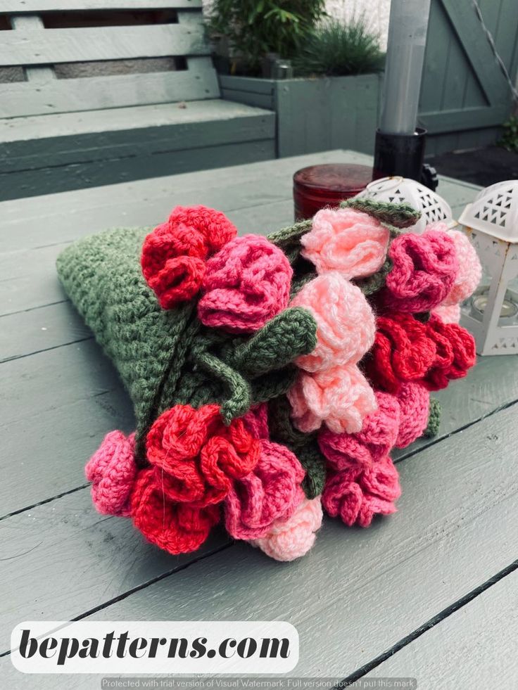 crocheted flowers are sitting on top of a blanket