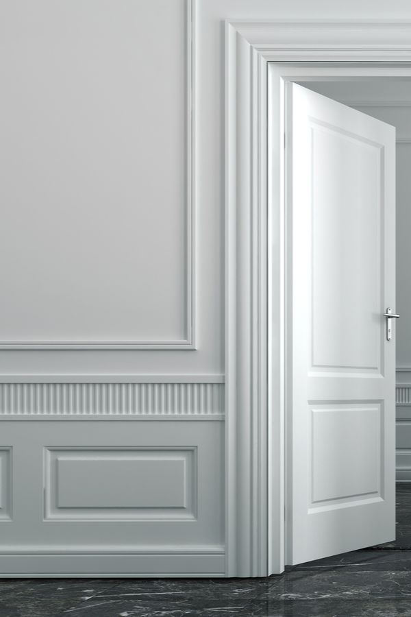 an open door in a white room with marble flooring