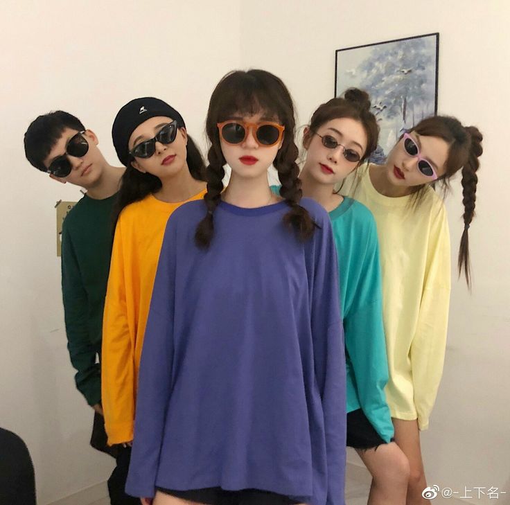 four models in colorful clothing and sunglasses posing for the camera