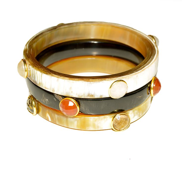 Horn is even more dramatic when embellished with crystals. Each bracelet has its own natural coloring - all beautiful. These are sold separately, please select your stone preference. You may also mix with other horn bracelets or gold bangles, the more different each bracelet, the more amazing the stack! Measures 2.5 inches in diameter. Luxury Gemstone Bangle Bracelets, Luxury Bangle Bracelets With Gemstone Accents, Luxury Bangle Bracelet With Natural Stones, Luxury Natural Stones Bangle, Unique Gemstone Accented Bangle Bracelets, Unique Bangle Bracelets With Gemstone Accents, Crystal Horn, Horn Bracelet, Gold Bangles