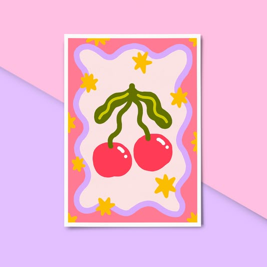 a card with two cherries on the front and one cherry on the back, against a pink background