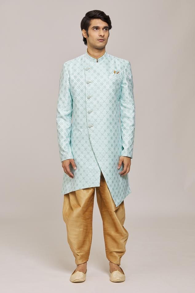 Firozi asymmetric sherwani with woven floral patterns. Comes with dhoti pant.
Components: 2
Pattern: Woven
Type Of Work: Floral
Neckline: Mandarin Collar
Sleeve Type: Full
Fabric: Sherwani: Mercury Jacquard Churidar: Silk Dupion
Color: Blue
Other Details: 
Embellished buttons
Closure:
Sherwani: Front button
Dhoti pant: Drawstring
Note: Pocket square worn by the model is not for sale
Occasion: Sangeet,Mehendi and Puja - Aza Fashions Traditional Fit Bollywood Sherwani With Pallu, Traditional Blue Sherwani For Navratri, Eid Traditional Bandhgala, Blue Traditional Wear With Naqshi Drape, Blue Traditional Wear With Naqshi, Traditional Fit Bandhgala For Eid, Eid Brocade Traditional Wear With Naqshi, Navratri Designer Sherwani With Naqshi Detailing, Designer Naqshi Sherwani For Navratri