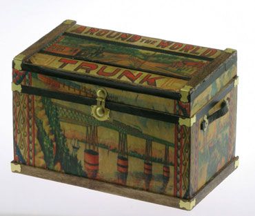 an ornate wooden box with decorative designs on it's lid and handles, sitting on a white surface