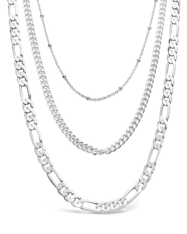 Layered necklaces are super on-trend, and these layered chains are sure to get you noticed everywhere you go! Choose between the gold and silver tones -- both are bright and bold, yet versatile enough to wear anywhere. Materials: 14K gold or rhodium plated brass Features: Measures 18-22" with 2" extender, 4.5mm Figaro chain, 3mm curb chain, 1mm beaded chain, Lead & Nickel free, lobster clasp Layered Chain Necklace Silver, Silver Necklaces Layered, Silver Layered Necklaces, Silver Chain Jewelry, Silver Necklace Chain, Necklaces Silver, Trending Bracelets, Layered Chain Necklace, Layered Necklaces Silver