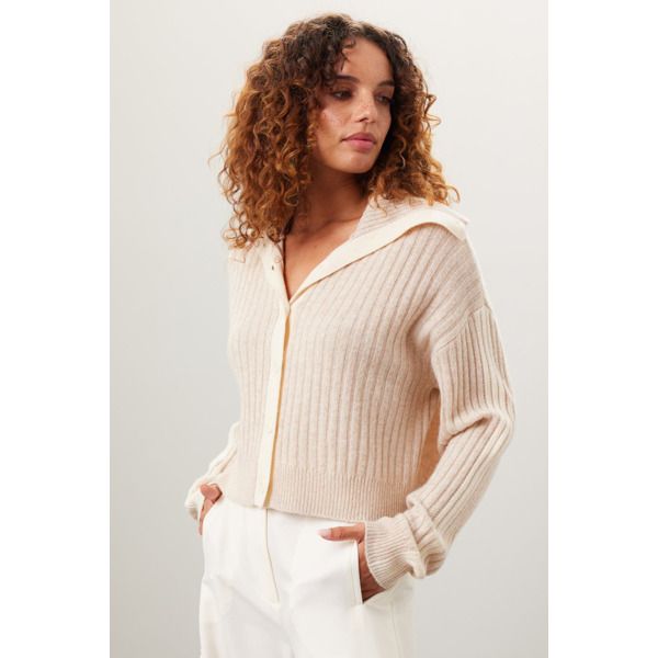 Off-white knit (90% Wool, 10% Cashmere). Sweater. Long sleeves. V-neck. Front button closure. 23" from shoulder to hemline. Imported. White V-neck Cardigan With Ribbed Cuffs, White Collared Ribbed Sweater, White Polo Sweater For Spring, Chic White Polo Sweater For Fall, White Ribbed Polo Sweater For Spring, White Collared Knit Sweater, White Collared Sweater With Ribbed Cuffs, White Collared Polo Sweater For Fall, White Workwear Cardigan With Ribbed Cuffs