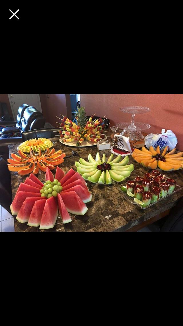 a table topped with lots of different types of fruit on top of a marble counter