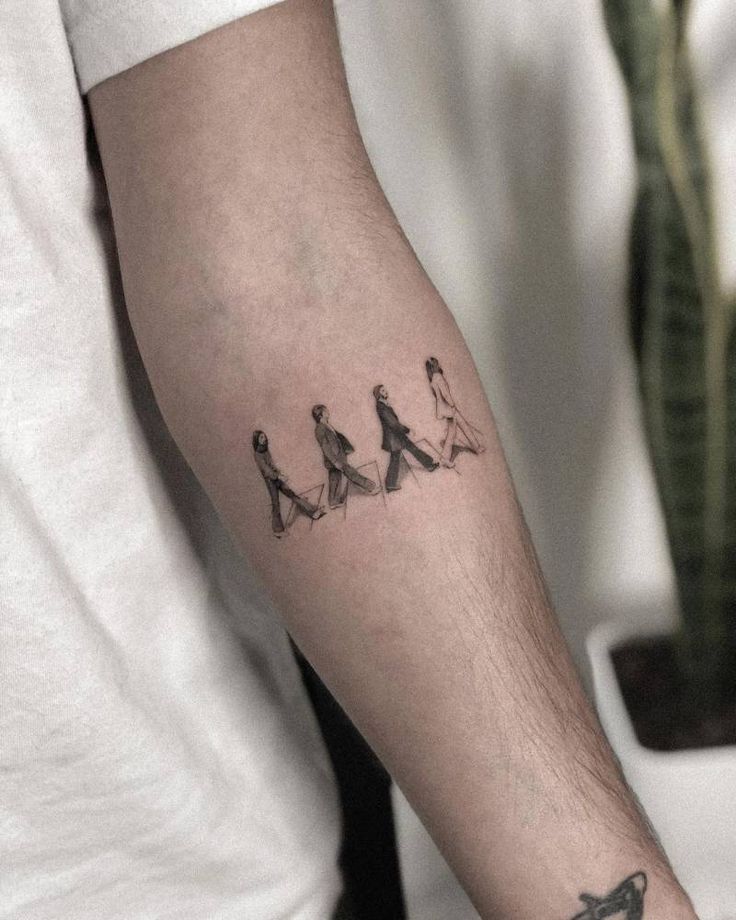 a man's arm with three birds on it