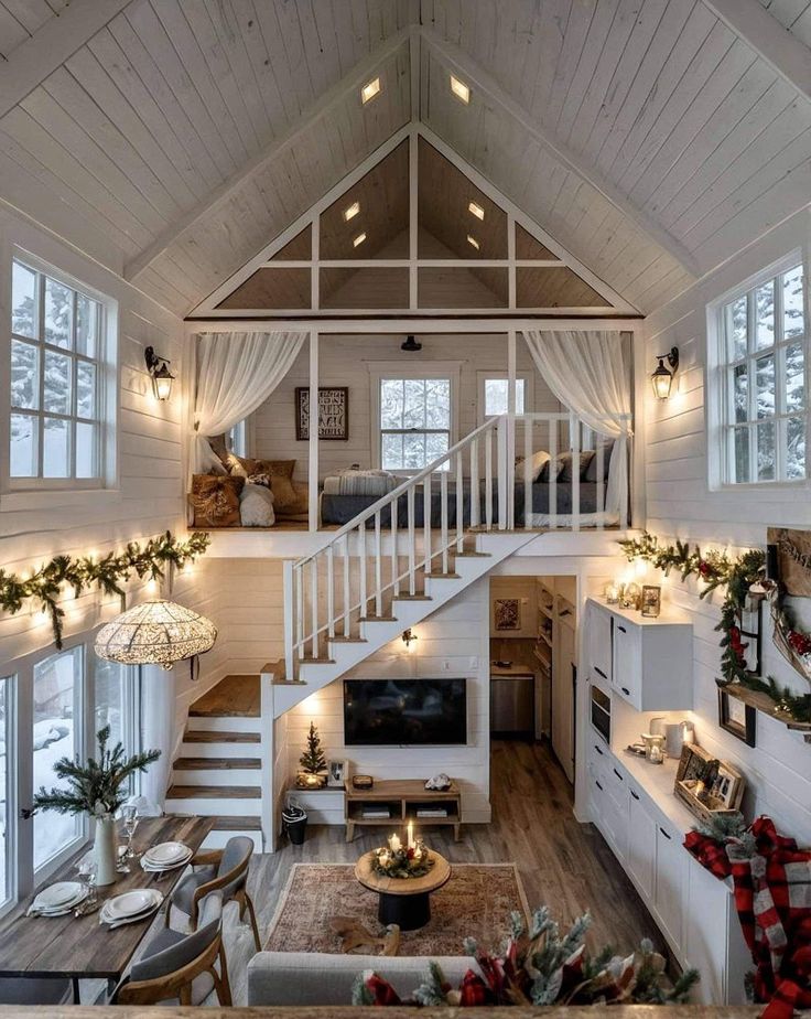 a living room filled with lots of furniture and christmas decorations on top of wooden floors