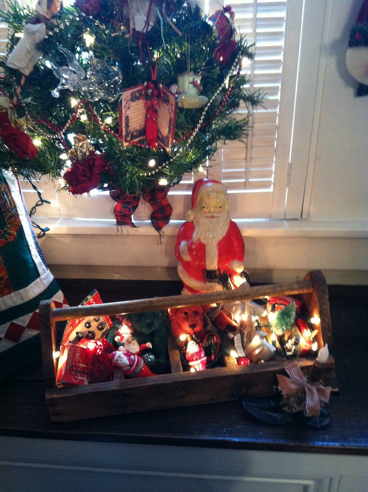 two wooden boxes filled with christmas decorations next to a window