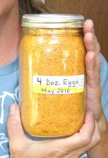 a woman holding a jar filled with food