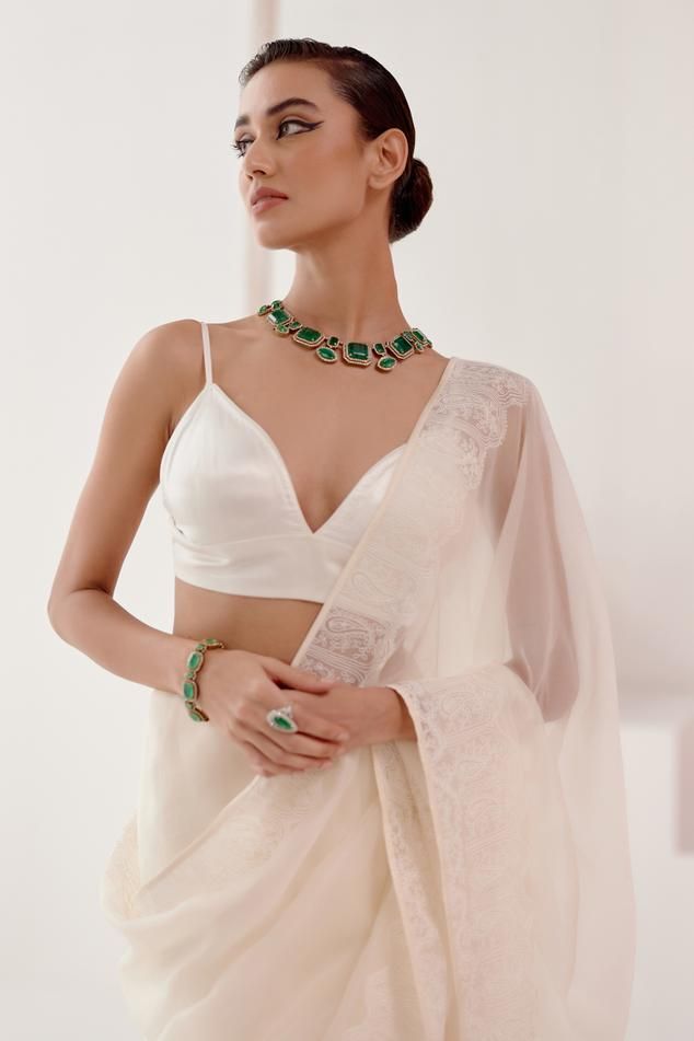 Ivory saree on silk organza base with dori embroidery and satin details with a tasselled lace on its palla. Comes with a gajji silk singlet blouse. - Aza Fashions Elegant Pre-draped Saree With Tilla For Diwali, Elegant V-neck Sets With Padded Blouse, Elegant V-neck Lehenga With Zari Work, Elegant Formal Blouse With Dupatta, Elegant Silk Choli For Designer Wear, Elegant V-neck Choli With Cutdana, Elegant Formal Tissue Silk Blouse, Elegant Designer Blouse With Sheer Dupatta, Elegant Georgette Blouse For Wedding