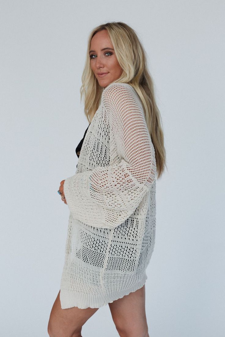 Our Brenden Knit Netted Cardigan is the perfect transitional cardigan. It has an airy and loose fit that layers beautifully over tank tops and dresses. It pairs well with shorts, skirts and pants. This versatile piece is a closet staple! Comfortable and lightweight open fabric Loose and slouchy cardigan silhouette Dropped shoulders with loose long sleeves *Due to lighting and differences in monitors, actual colors may vary slightly from what appears online. Model is 5'8" and wearing a size One S Slouchy Cardigan, Crochet Bralette, White Bralette, Shorts Skirts, Floral Print Skirt, Boho Look, And Dresses, Wide Sleeves, Black Cardigan