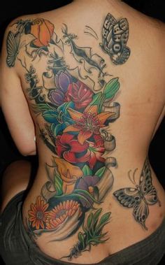 a woman's back with flowers and butterflies on it