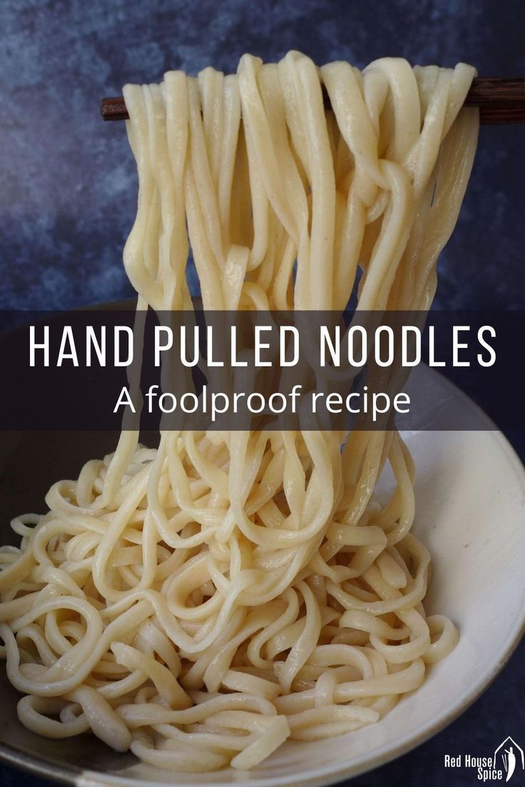 noodles being lifted from a bowl with the words hand pulled noodles above them