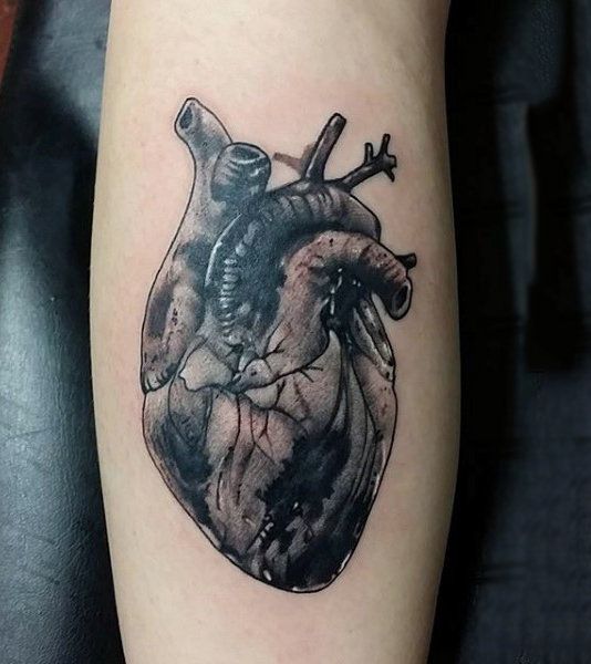 a black and white heart tattoo on the arm