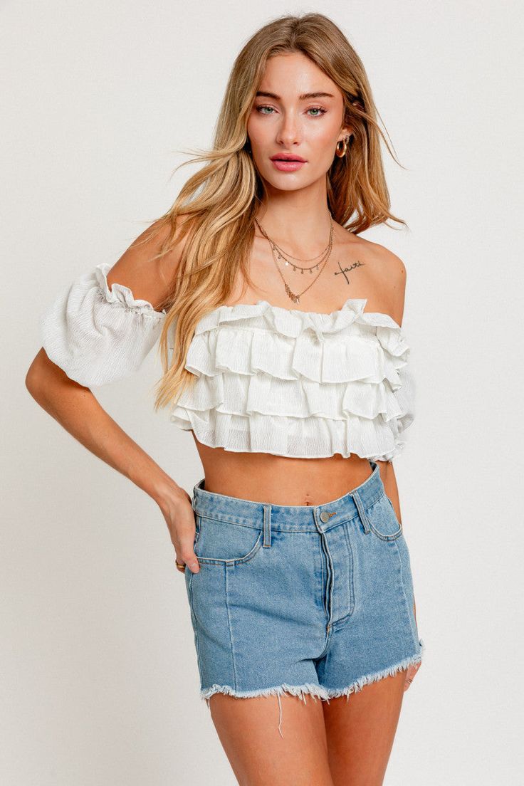 Off the shoulder top with back bow closure. Frills and ruffled detail. MODEL IS WEARING A SIZE SMALL FABRIC CONTENT: 60% RAYON 40% COTTON Boho Crop Tops, Outfits Rave, Short Puff Sleeve, Ruffle Crop Top, White Off Shoulder, Womens Tops Summer, Striped Crop Top, Solid Tops, White Crop Top