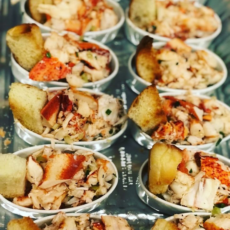 many small bowls filled with food on top of a table