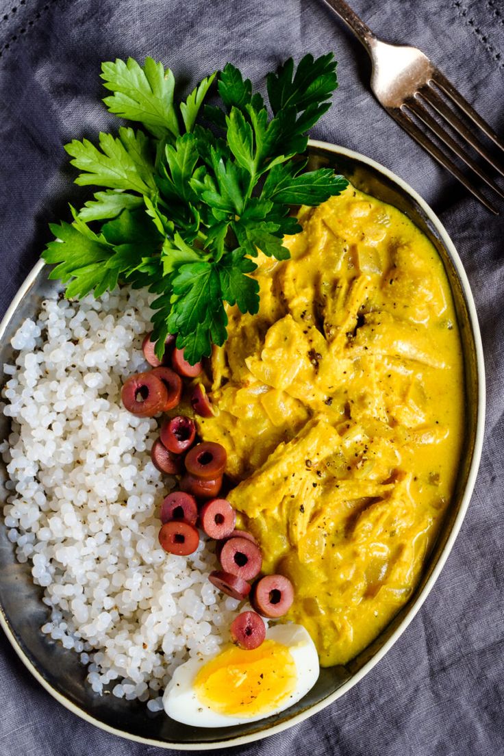 a plate with rice, eggs and meat on it