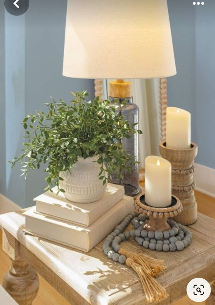 a table with some books and candles on it