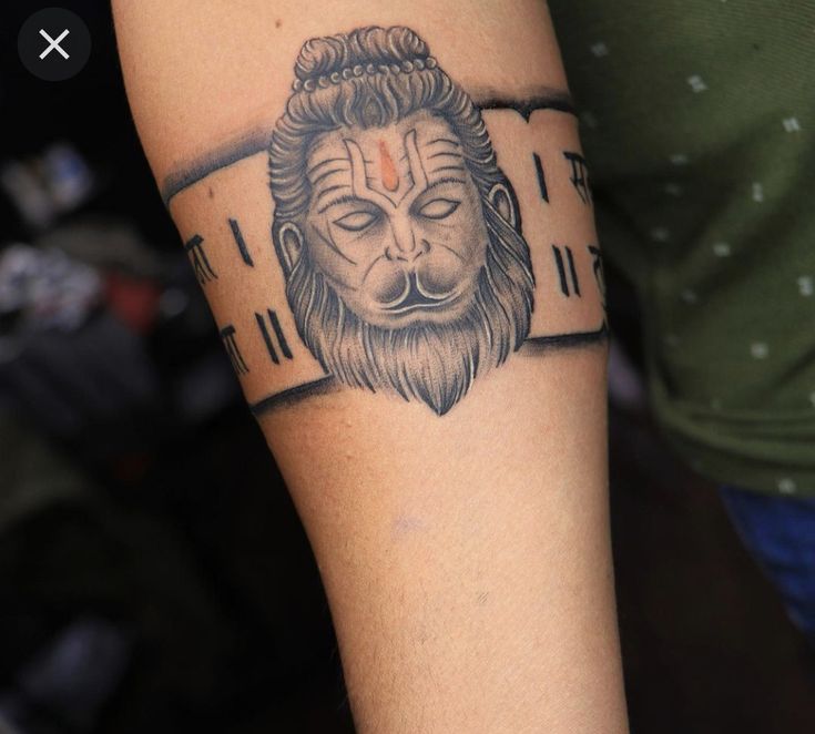 a man with a lion tattoo on his arm