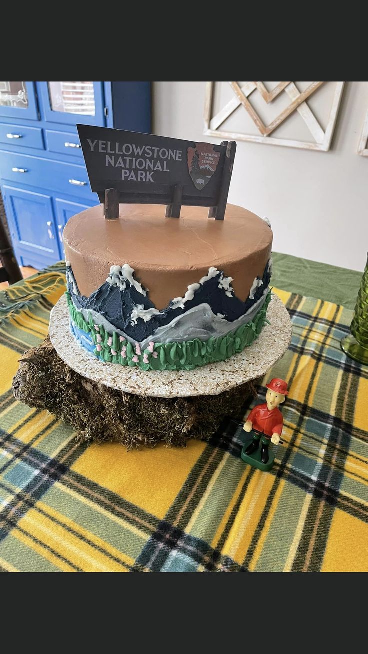 a cake sitting on top of a table covered in frosting