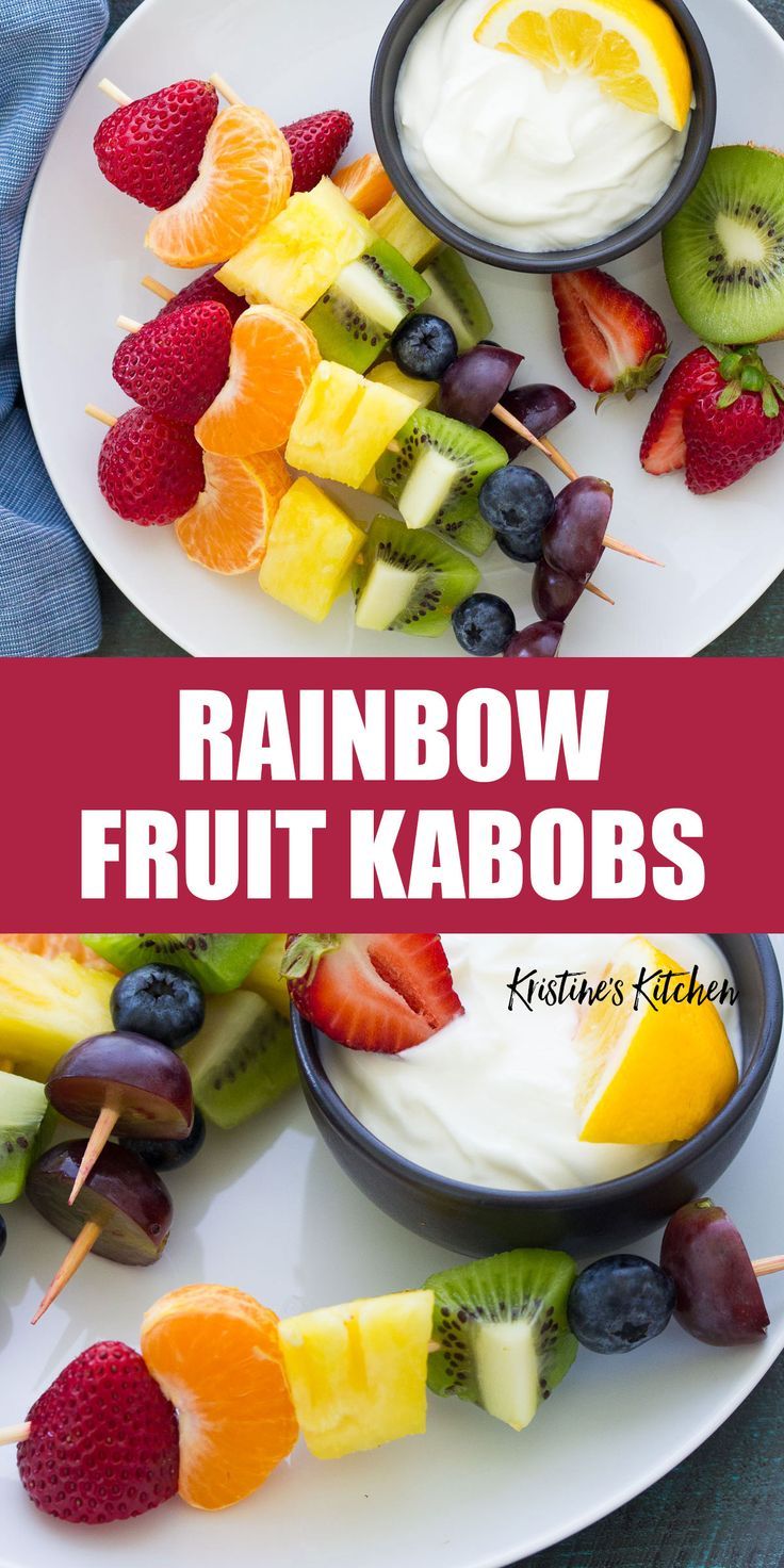 rainbow fruit kabobs with yogurt and strawberries on a white plate