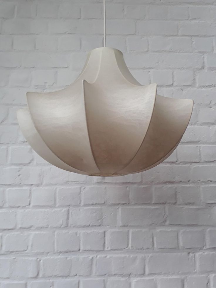 a white light hanging from a brick wall