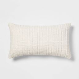 a white pillow sitting on top of a white wall