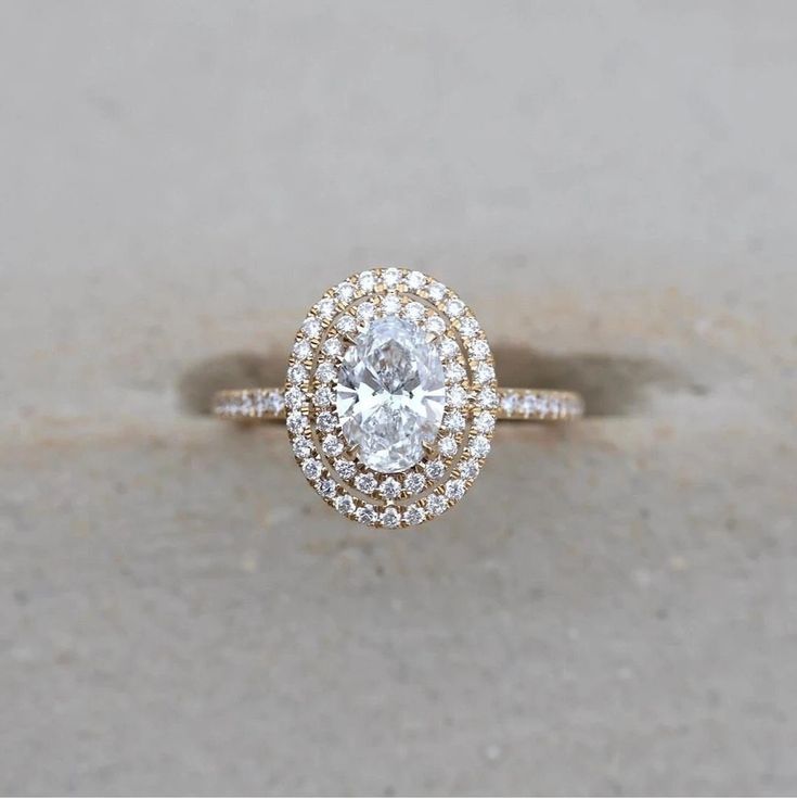 a close up of a diamond ring on concrete